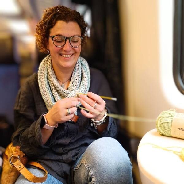 Woolster crocheting on a train